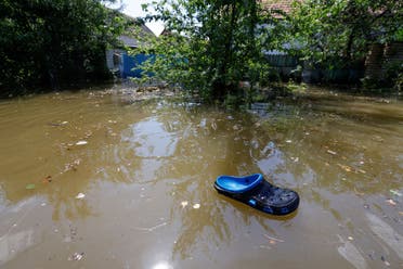 slipper is seen adrift in a flooded residential area, that submerged in water following the collapse of the Nova Kakhovka dam in the course of Russia-Ukraine conflict, in the town of Nova Kakhovka. (Reuters)