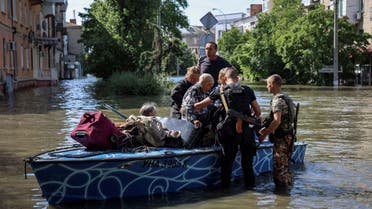 Police evacuate local residents from a flooded area after the Nova Kakhovka dam breached, amid Russia's attack on Ukraine, in Kherson, Ukraine June 7, 2023. REUTERS (4)