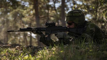 A Swedish Home Guard soldier fires a shot as he takes part in a field exercise near Visby on the Swedish island of Gotland on May 17, 2022. (AFP)