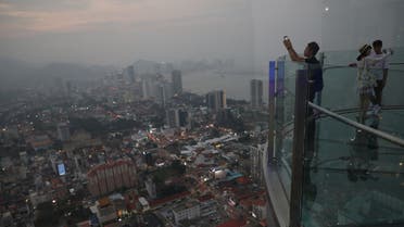 Tourists take pictures of the skyline at The Top Komtar, in Penang, Malaysia, September 20, 2019. (Reuters)