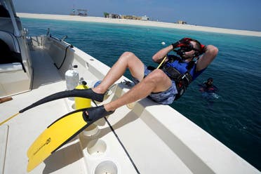 Zack Heikal, Field Technician of the Environmental Agency Abu Dhabi, dives into the water to visit a coral reef nursery off the coast of Abu Dhabi, United Arab Emirates, Thursday, May 25, 2023. (AP)