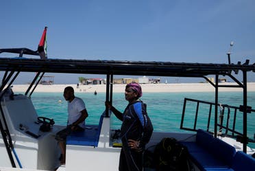 A diver looks out from the boat near the Island of Um Khorah, the center of Abu Dhabi's Coral Reef Rehabilitation project, on a trip to restore corals in Abu Dhabi, United Arab Emirates, Thursday, May 25, 2023. (AP)