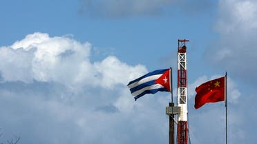 Cuba and China's flags are seen near an oil rig in Santa Cruz del Norte, March 24, 2007. REUTERS/Claudia Daut (CUBA)