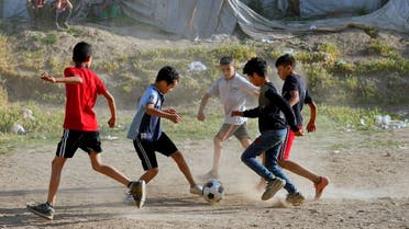 Syrian children play soccer by their tents at a refugee camp in the town of Bar Elias, in Lebanon's Bekaa Valley, Tuesday, June 13, 2023.