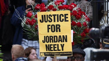 People hold a placard on the day of Jordan Neely's funeral, a man whose death has been ruled a homicide by the city's medical examiner after being placed in a chokehold on a subway train by former U.S. Marine Daniel Penny, in New York City, U.S., May 19, 2023. REUTERS/Shannon Stapleton