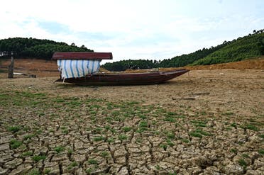A boat stranded on cracked soil on an island formed inside Thac Ba hydropower lake in Yen Bai province. Vietnam, which relies on hydropower for almost half its energy needs, June 13, 2023. (AFP)