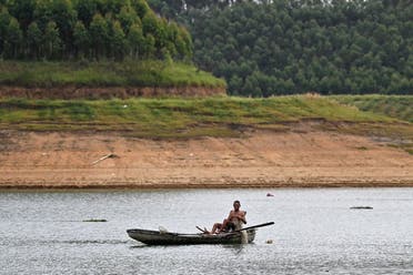A fisherman sails a boat inside Thac Ba hydropower lake in Yen Bai province. After a series of heatwaves, including a record high in May, and an unprecedented drought, June 13, 2023. (AFP)