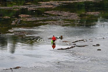 Local residents fishing on Chay river at the lower section of Thac Ba hydropower dam in Yen Bai province, June 14, 2023. (AFP)