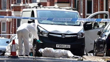 Police forensics officers work around a white van with a shattered windscreen, inside a police cordon on Bentinck Road in Nottingham, central England, following a ‘major incident’ in which three people were found dead. (AFP)