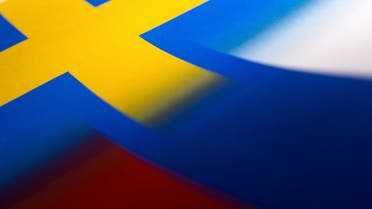 Swedish and Russian flags are seen printed on paper this illustration taken April 13, 2022. (Reuters)