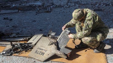 A police officer inspects parts of an unmanned aerial vehicle (UAV), what Ukrainian authorities consider to be an Iranian made suicide drone Shahed-136, at a site of a Russian strike on fuel storage facilities, amid Russia's attack on Ukraine, in Kharkiv, Ukraine October 6, 2022. (Reuters)