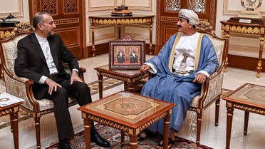 This handout picture released by the Omani Royal Palace shows Oman’s Minister of the Royal Office Sultan bin Mohammed al-Numani (R) receiving Iran’s Foreign Minister Hossein Amir-Abdollahian in Muscat on June 21, 2023. (AFP)