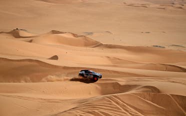 Swedish driver Mattias Ekstrom and his co-driver Emil Bergkvist of Sweeden compete in their Audi electric during the Stage 8 of the Dakar Rally 2022 between al-Dawadimi and Wadi Ad-Dawasir in Saudi Arabia, on January 10, 2022. (AFP)