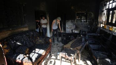 Palestinians inspect the damage to a Palestinian house after it was set on fire by Jewish settlers in the West Bank town of Turmus Ayya on Wednesday, June 21, 2023.