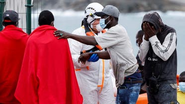 Rescuers help a migrant disembark from a Spanish coast guard boat, at the port of Arguineguin, in the island of Gran Canaria, Spain, June 19, 2023. (Reuters)