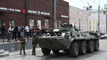 Fighters of Wagner private mercenary group stand next to an armored vehicle in a street in the city of Rostov-on-Don, Russia, on June 24, 2023. (Reuters)