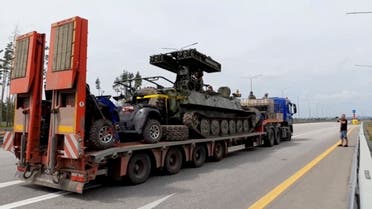 A truck transporting a military vehicle of Wagner private mercenary group drives along M-4 highway, which links the capital Moscow with Russia’s southern cities, near Voronezh, Russia, on June 24, 2023 in this still image taken from video. (Reuters)