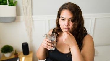Sick young woman taking medication stock photo
