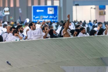 This handout picture provided by the Saudi Press Agency SPA on June 28, 2023 shows Muslim pilgrims performing the symbolic stoning of the devil ritual, as part of the Hajj pilgrimage in Mina near Saudi Arabia's holy city of Mecca. (SPA)