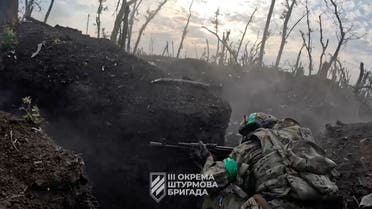 A Ukrainian armed forces member moves through the terrain during an operation, amid Russia's invasion of Ukraine, in a location given as near Bakhmut, Donetsk region, Ukraine in this screengrab taken from a video released June 25, 2023. 3rd assault brigade/Ukrainian Armed Forces Press Service/Handout via REUTERS THIS IMAGE HAS BEEN SUPPLIED BY A THIRD PARTY. MANDATORY CREDIT. REUTERS WAS NOT ABLE TO CONFIRM THE DATE OR LOCATION THE VIDEO WAS FILMED.