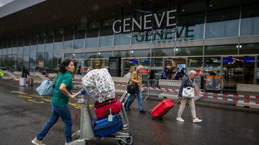 Travellers arrives at Geneva's international airport during strikes on June 30, 2023. Flights at Geneva's international airport will be grounded for four hours due to a workers' strike, affecting thousands of passengers at the start of summer travel season. (Photo by Fabrice COFFRINI / AFP)