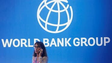 A participant stands near a logo of the World Bank at the International Monetary Fund - World Bank Annual Meeting. (File photo: Reuters)