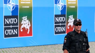 A security officer stands guard as Turkish President and Swedish Prime Minister attend a meeting a day before the start of a NATO summit, in Vilnius, Lithuania, on July 10, 2023. (Photo by YVES HERMAN / POOL / AFP)