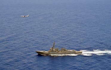 A P-8A Poseidon attached to Maritime Patrol Squadron (VP) 8 flies over the guided-missile destroyer USS Momsen (DDG 92) in the South China Sea. (File photo: Reuters)
