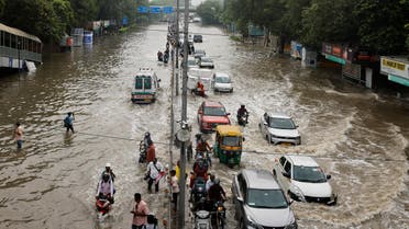 Traffic moves through a flooded road, after a rise in the waters of river Yamuna due to heavy monsoon rains, in New Delhi, India, July 14, 2023. (Reuters)
