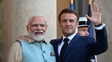 French President Emmanuel Macron (R) welcomes Indian Prime Minister Narendra Modi for a dinner at the Elysee Palace in Paris on July 13, 2023. (Reuters)