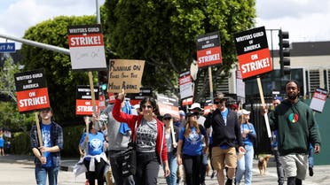 FILE PHOTO: Workers and supporters of the Writers Guild of America protest outside Universal Studios Hollywood after union negotiators called a strike for film and television writers, in the Universal City area of Los Angeles, California, U.S., May 3, 2023. REUTERS/Mario Anzuoni/File Photo