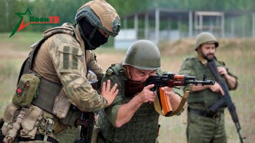 A fighter from Russian Wagner mercenary group conducts training for Belarusian soldiers on a range near the town of Osipovichi, Belarus July 14, 2023 in this still image taken from handout video. (Reuters)
