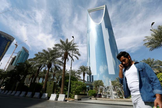 A man speaks on the phone as he walks past the Kingdom Centre Tower in Riyadh, Saudi Arabia. (File photo: Reuters)