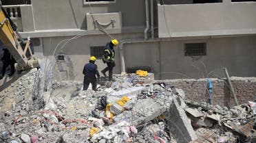 File photo of rescurers work at the site where a building collapsed in Gesr al-Suez, Cairo, Egypt. (Reuters)