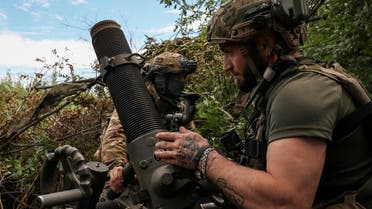 Ukrainian servicemen, of the 10th separate mountain assault brigade of the Armed Forces of Ukraine, prepare to fire a mortar at their positions at a front line, amid Russia's attack on Ukraine, near the city of Bakhmut in Donetsk region, Ukraine July 13, 2023. (Reuters)