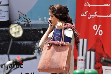 An Iranian woman walks in Tehran on July 18, 2023, as the police relaunched patrols to catch the increasing number of women leaving their hair uncovered in public in defiance of a strict dress code. (AFP)