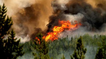 Flames from the Donnie Creek wildfire burn along a ridge top north of Fort St. John, British Columbia, Canada, Sunday, July 2, 2023. (AP)