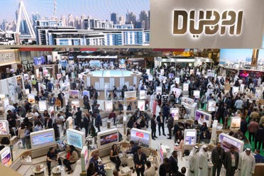 This picture shows people visiting the booth of UAE's Emirates airline during the Arabian Travel Market exhibition in Dubai May 2, 2023. (AFP)