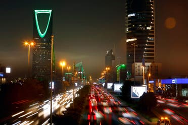 In this photo taken with a slow shutter speed, vehicles pass in front of the Kingdom Tower, left, in Riyadh, Saudi Arabia, Sept. 22, 2019. (File photo: AP)