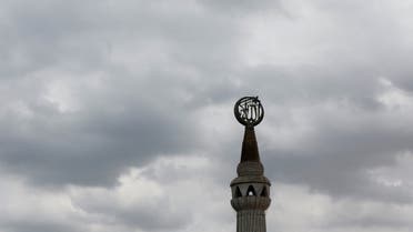 A religious sign is seen on a mosque with the monsoon clouds in the background, in Karachi, Pakistan July 23, 2023. (Reuters)