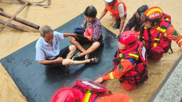 FILE PHOTO: Firefighters evacuate residents stranded by floodwaters after Typhoon Doksuri made landfall in Quanzhou, Fujian province, China July 28, 2023. cnsphoto via REUTERS ATTENTION EDITORS - THIS IMAGE WAS PROVIDED BY A THIRD PARTY. CHINA OUT./File Photo
