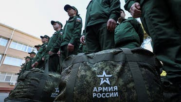 FILE PHOTO: Russian conscripts called up for military service line up before their departure for garrisons as they gather at a recruitment centre in Simferopol, Crimea, April 25, 2023. Signs on bags read: Army of Russia. REUTERS/Alexey Pavlishak/File Photo