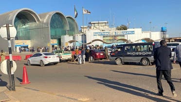 People wait outside Khartoum International Airport, in Khartoum, Sudan, Tuesday, Jan. 14, 2020. (AP)