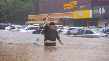 A man walks through a flooded street in a neighbourhood where days of heavy rain from remnants of Typhoon Doksuri cause heavy damage in Beijing, China, August 1, 2023. (Reuters)