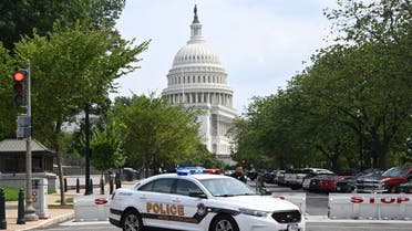 A US Capitol police officer stands by his car outside the Russell Senate Office Building in Washington, DC, on August 2, 2023, after unconfirmed eports of an active shooter in the building near the US Capitol. (Photo by SAUL LOEB / AFP)