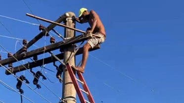 This handout picture released by the Minas Gerais Fire Department show a fugitive climbed on an electric pole while escaping from the police in the town of Itabira, Brazil on August 5, 2023. (AFP)