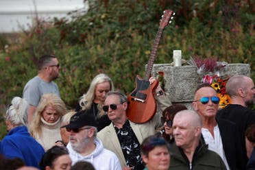 Fans gather outside the former home of Sinead O'Connor ahead of the late singer's funeral, in Bray, Co Wicklow, Ireland, Tuesday, Aug. 8, 2023. (AP)