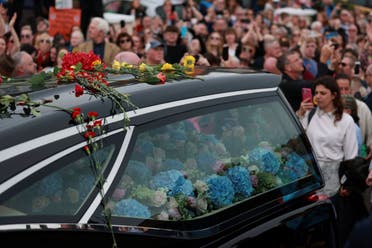 Fans of Sinéad O'Connor surround her funeral procession in Bray, the singer's hometown in County Wicklow, Ireland, on Tuesday, August 8, 2023. (AP)