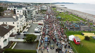 Fans of Sinead O'Connor line the street as her funeral cortege passes through her former hometown of Bray, Co Wicklow, Ireland, Tuesday, Aug. 8, 2023. (AP)