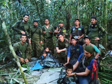 In this photo released by Colombia's Armed Forces Press Office, soldiers and Indigenous men pose for a photo with the four children who were missing after surviving a deadly plane crash, in the Solano jungle, Caqueta state, Colombia, June 9, 2023. (AP)